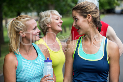 Marathon female athlete talking and drinking water