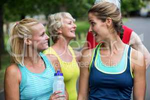 Marathon female athlete talking and drinking water