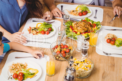 High angle view of family with food on dining table