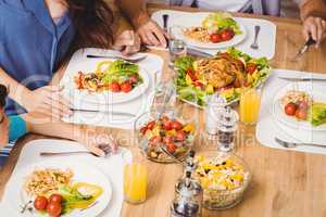 High angle view of family with food on dining table