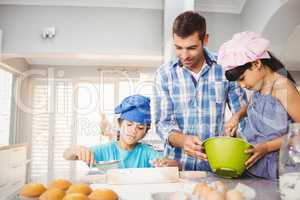 Children helping father in preparing food