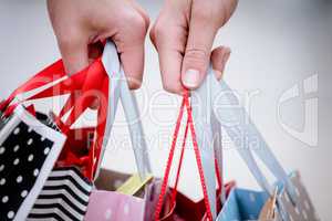 Close-up of two women carrying shopping bags