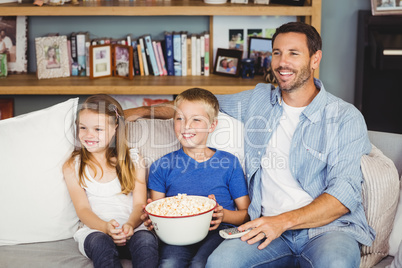 Cheerful family with popcorns while watching television
