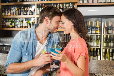 Couple toasting with cocktails