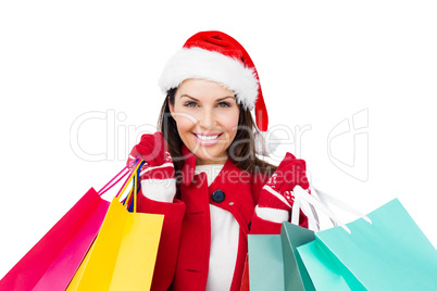 Beautiful brunette with santa hat holding shopping bags