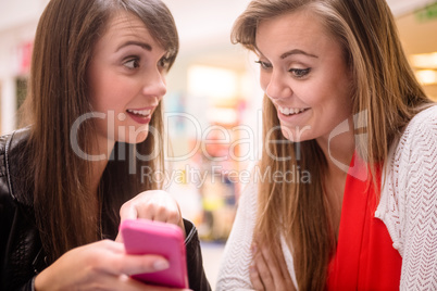 Two women looking at mobile phone