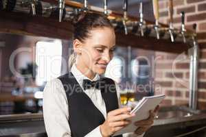 Barmaid taking orders on notepad