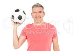 Happy football fan holding ball