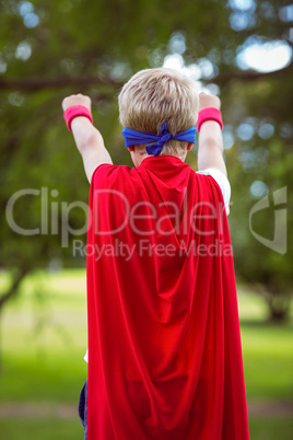Rear view of a little boy pretending to be superhero