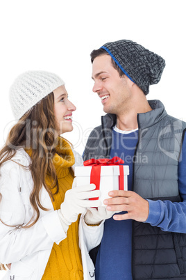 Happy couple holding gift box together