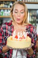 Woman blowing out candles