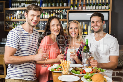 Friends holding glasses of white wine