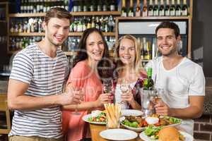 Friends holding glasses of white wine