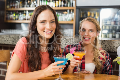 Women holding glasses of cocktail