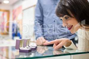 Happy woman selecting a finger ring