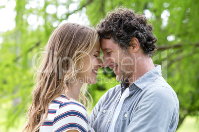 Smiling couple embracing head to head
