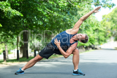 Sportsman stretching in park