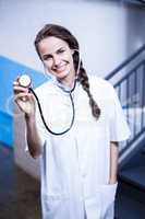 Portrait of female doctor showing stethoscope