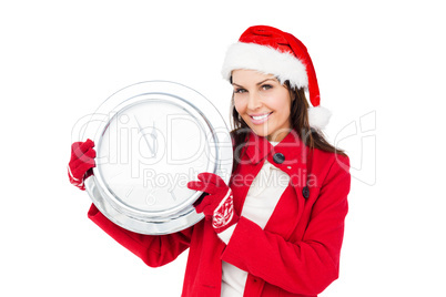 Beautiful brunette with santa hat holding a clock