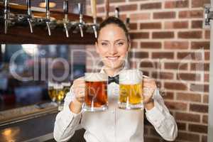 Female bartender holding beers