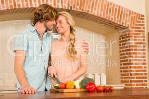 Cute couple slicing vegetables