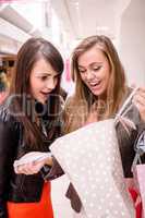 Two woman looking in the shopping bag