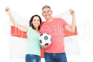 Excited football fan couple cheering at camera