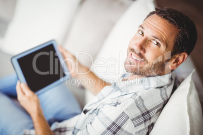 Portrait of smiling man holding digital tablet