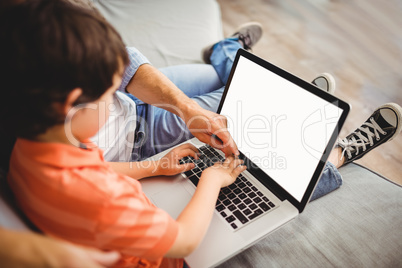 Father and son working on laptop