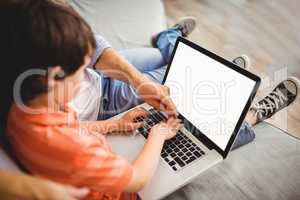 Father and son working on laptop