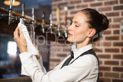 Barmaid cleaning a glass