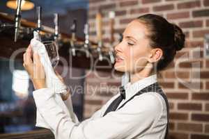 Barmaid cleaning a glass