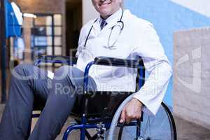Male doctor sitting on wheel chair