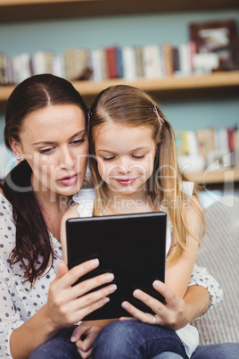 Close-up of mother and daughter looking in digital tablet