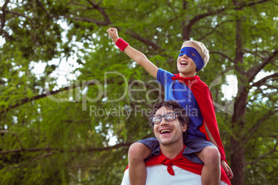 Father and son pretending to be superhero