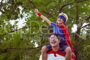 Father and son pretending to be superhero