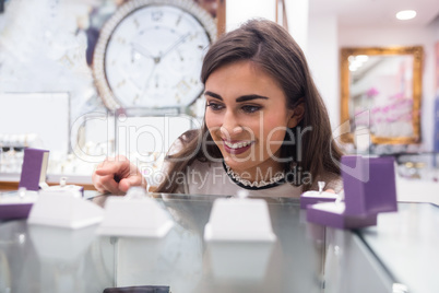 Happy woman selecting a finger ring