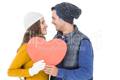 Happy couple holding paper heart