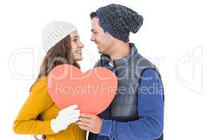 Happy couple holding paper heart