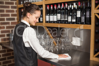 Barmaid cleaning table