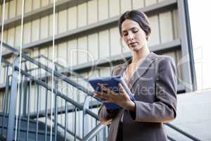 Beautiful businesswoman using digital tablet