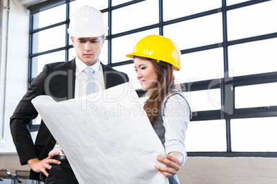 Architects looking at blueprint