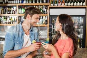 Couple toasting with cocktails