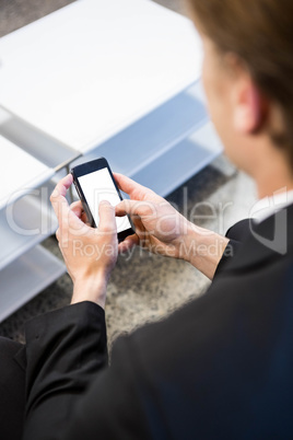Businessman text messaging on smartphone Businessman text messaging on smartphone
