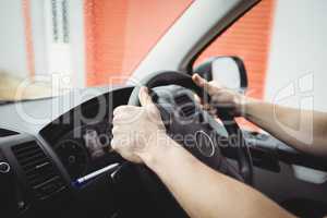 Close-up of hands holding steering wheel