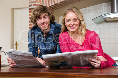 Cute couple reading the newspaper