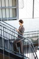 Beautiful businesswoman on staircase