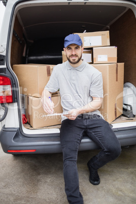 Delivery man writing on clipboard