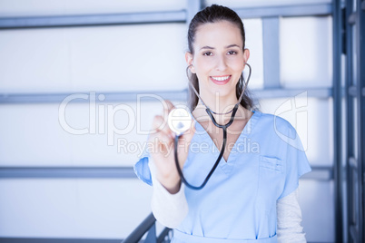 Portrait of female doctor showing stethoscope