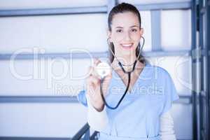 Portrait of female doctor showing stethoscope